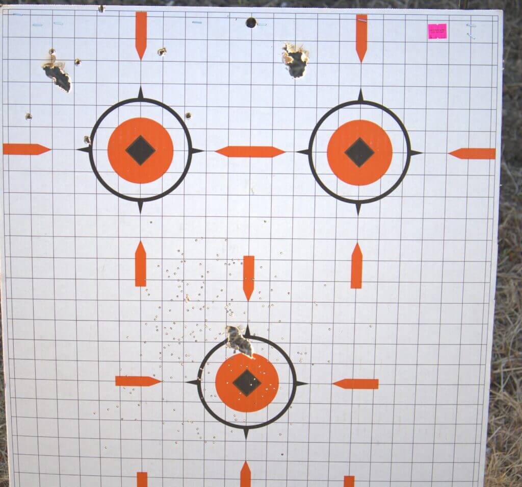 Charles Daly Honcho shotgun patterns at twenty feet on white board with orange targets