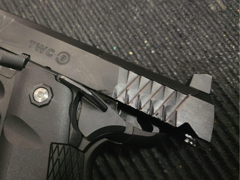 pistol with slide locked back showing robust iron sights