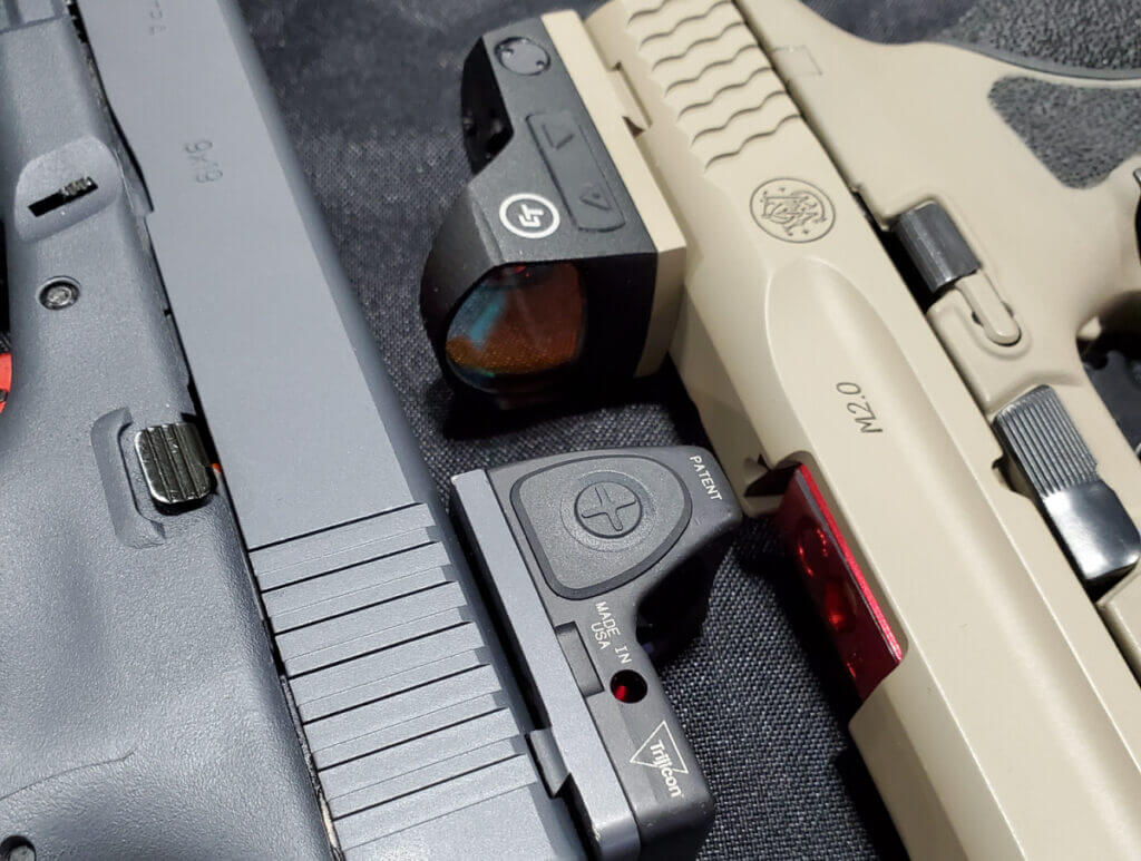 handguns with mounted red dot optics on the firing line