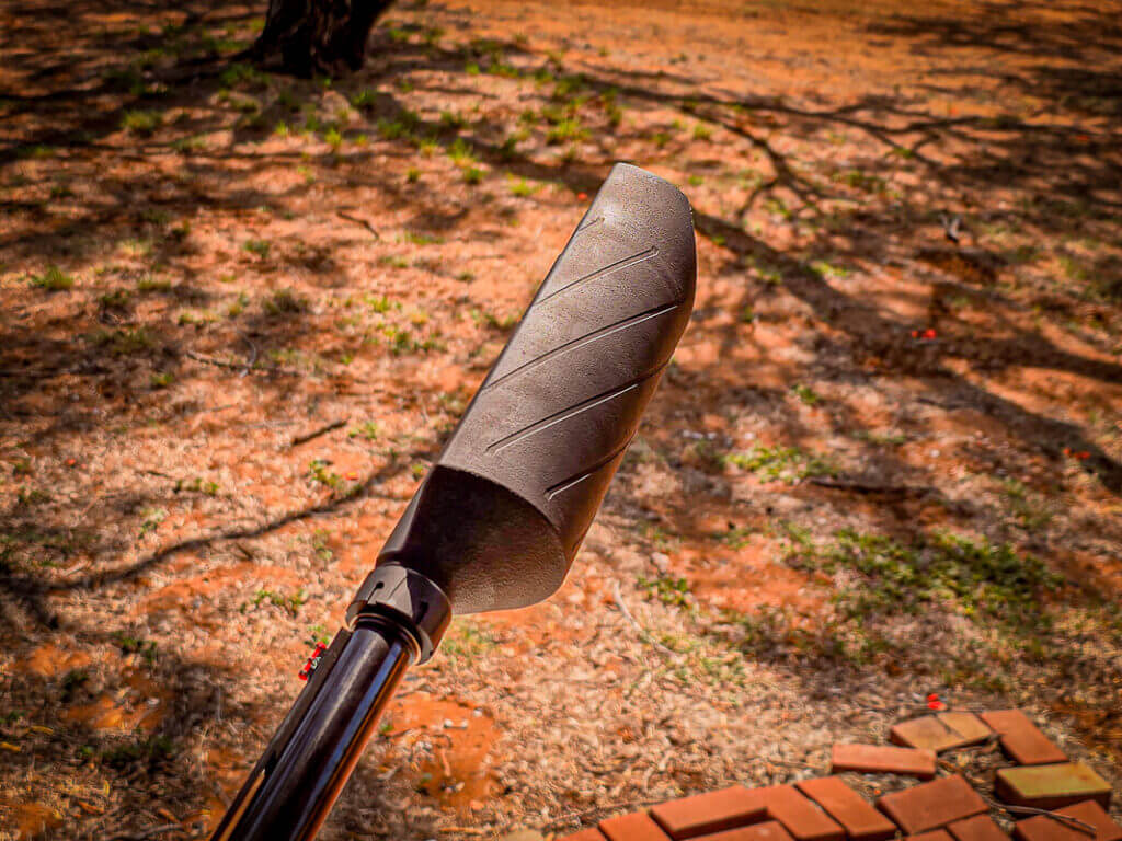 Silencer Central Banish 12 shotgun suppressor side profile showing half can design