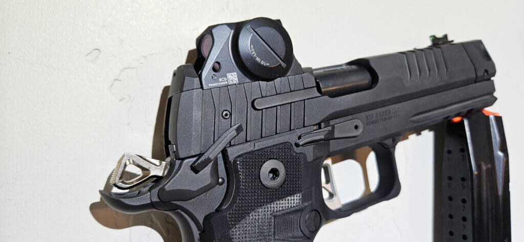 Close view of Sig P211 GTO controls with low mounted ROMEOX optic co-witnessing iron sights