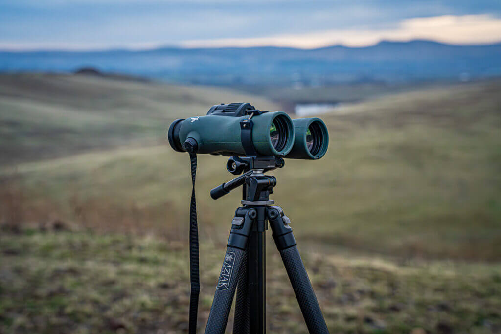 Aziak bino clamp attaching Swarovski NL Pure 12x42 binoculars to Ridge Warden head