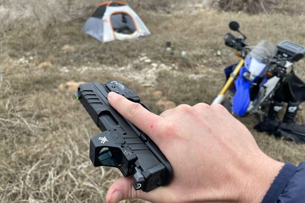 Echelon 4.0C grip texture with dirt bike and tent in background at riverside camp