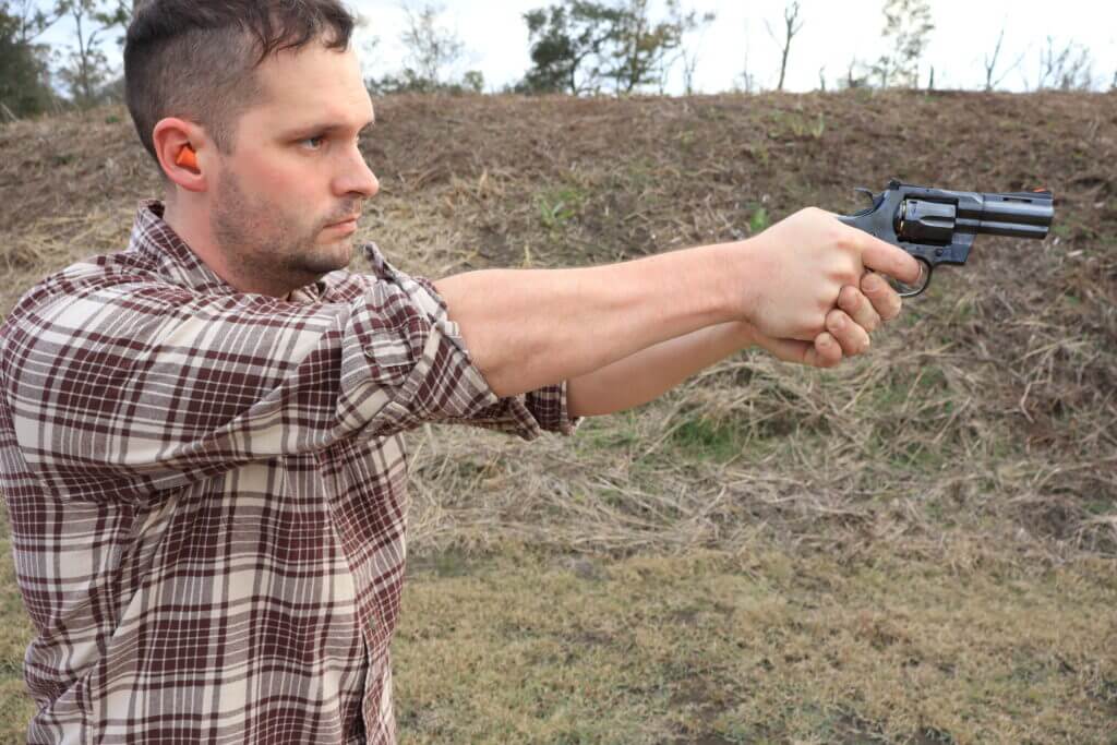 Jim Maybrick aiming the blued Colt Python during live-fire range testing