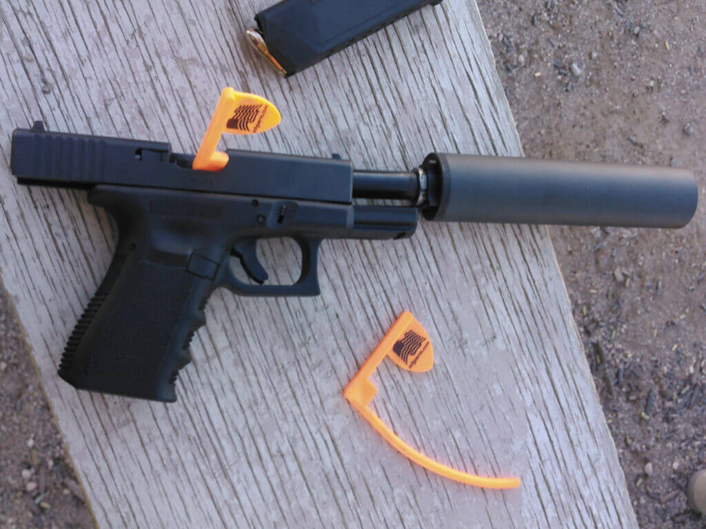 Glock handgun with pistol suppressor attached for home defense