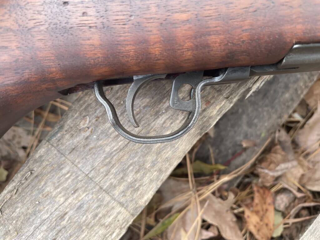 M1 Garand safety lever located at the front of the trigger guard in the on position