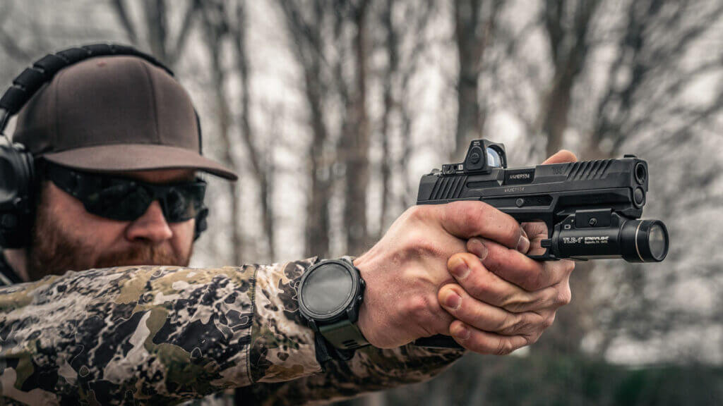 Taurus TX9 on plate rack range session, weapon light attached