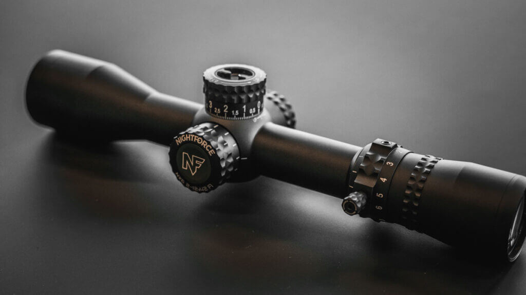 Nightforce NX6 2-12x42mm on rifle, side profile with capped turrets