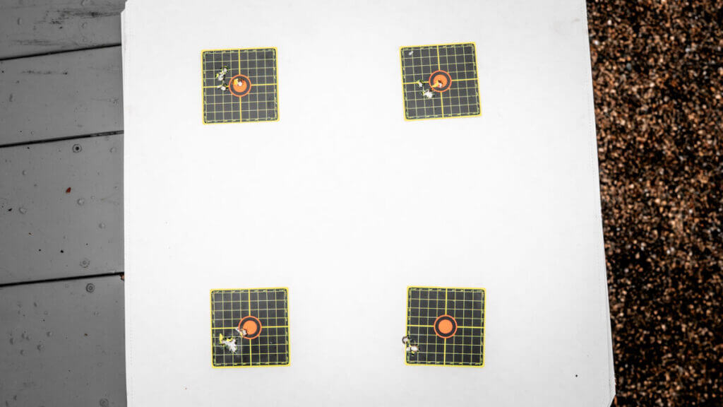 Seekins SIC rifle shooting on a snowy range with suppressor glowing from heat