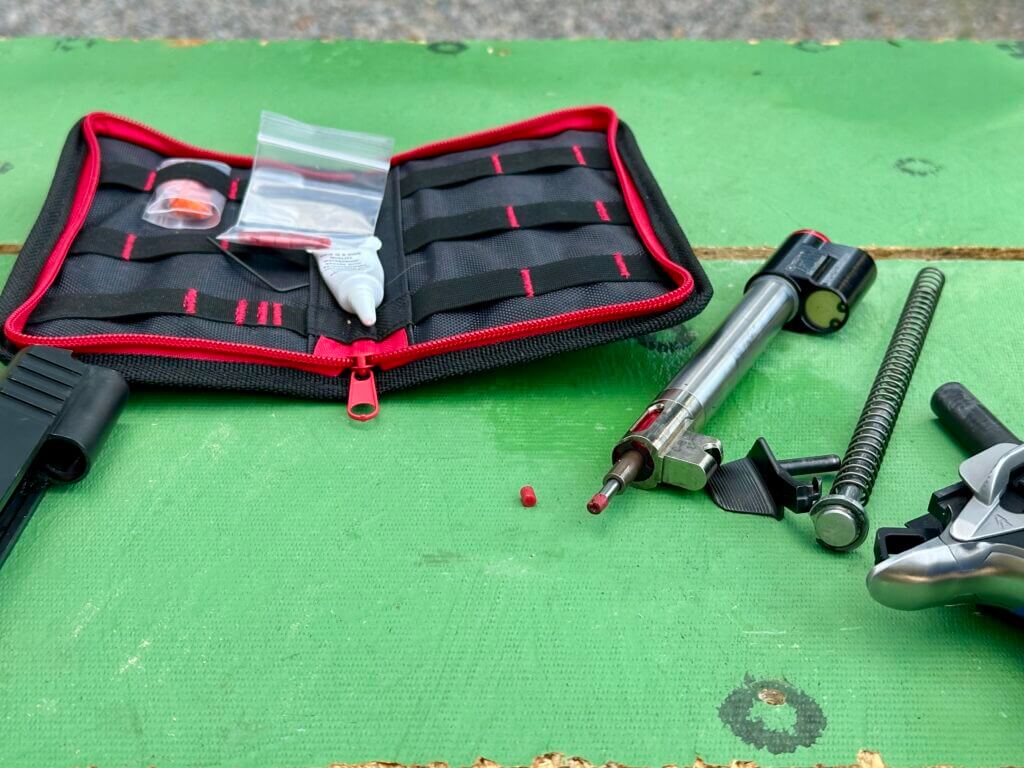 Close-up of CoolFire Trainer Striker Tip wear next to new replacement insert