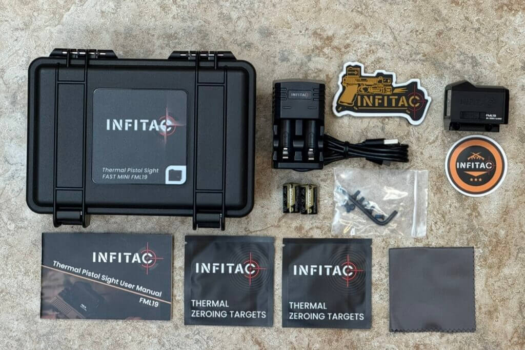 Infitac FML19 full kit laid out with RMR adapter, charger, CR2 batteries, tools, and zero targets