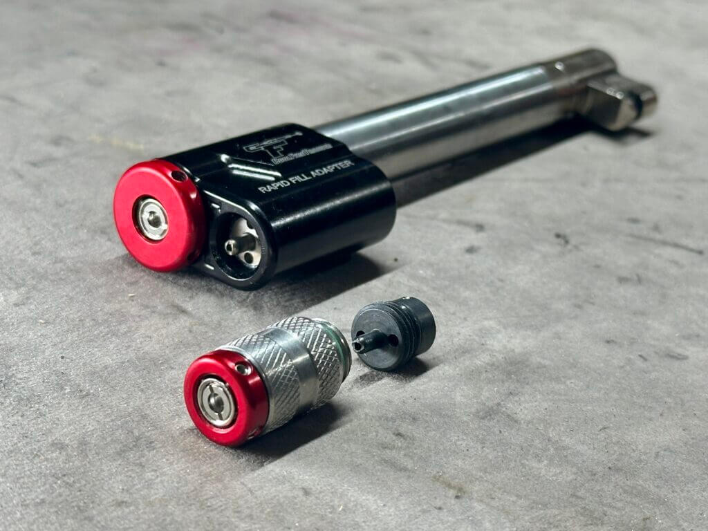 CoolFire Trainer barrel with laser modules including Rapid Fill Adapter Laser on tabletop