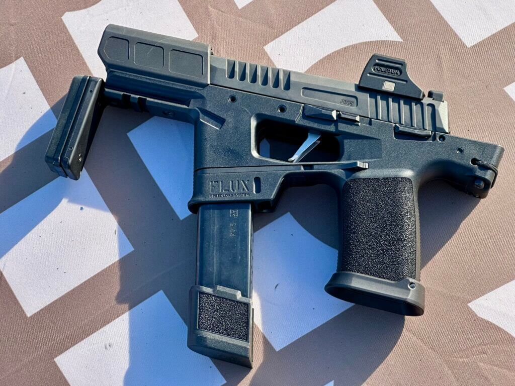 A folded black PDW lays on the table.