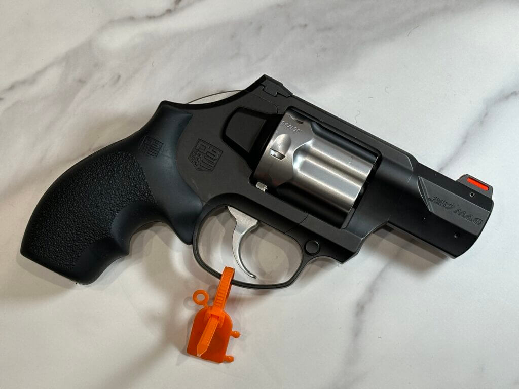 Looking down on a revolver that lays on its side.