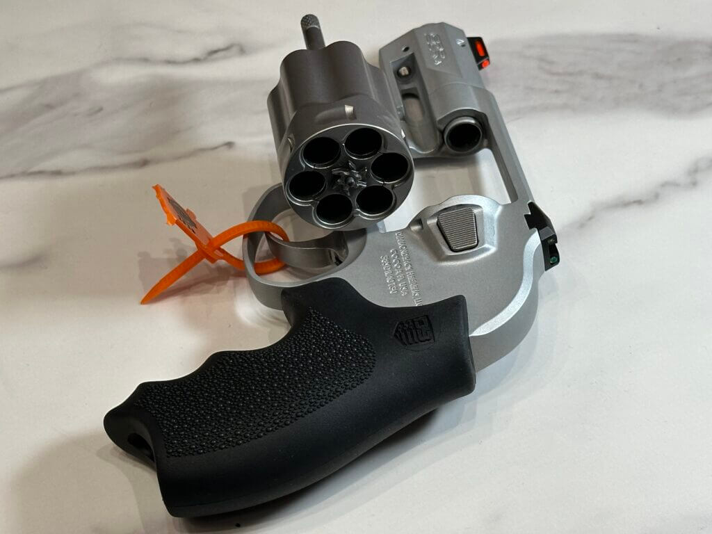 Looking from behind the pistol into the cylinder, which is open for us to see.