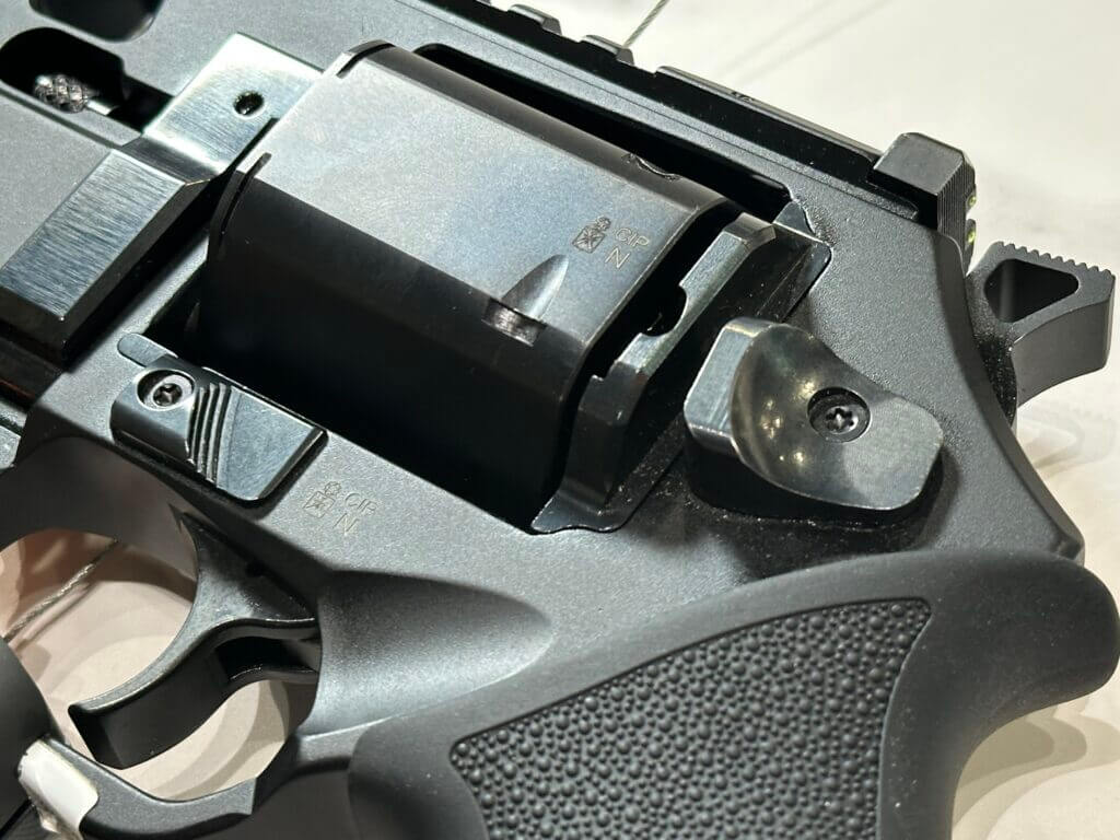 Closeup view of the cylinder and controls on a black revolver.