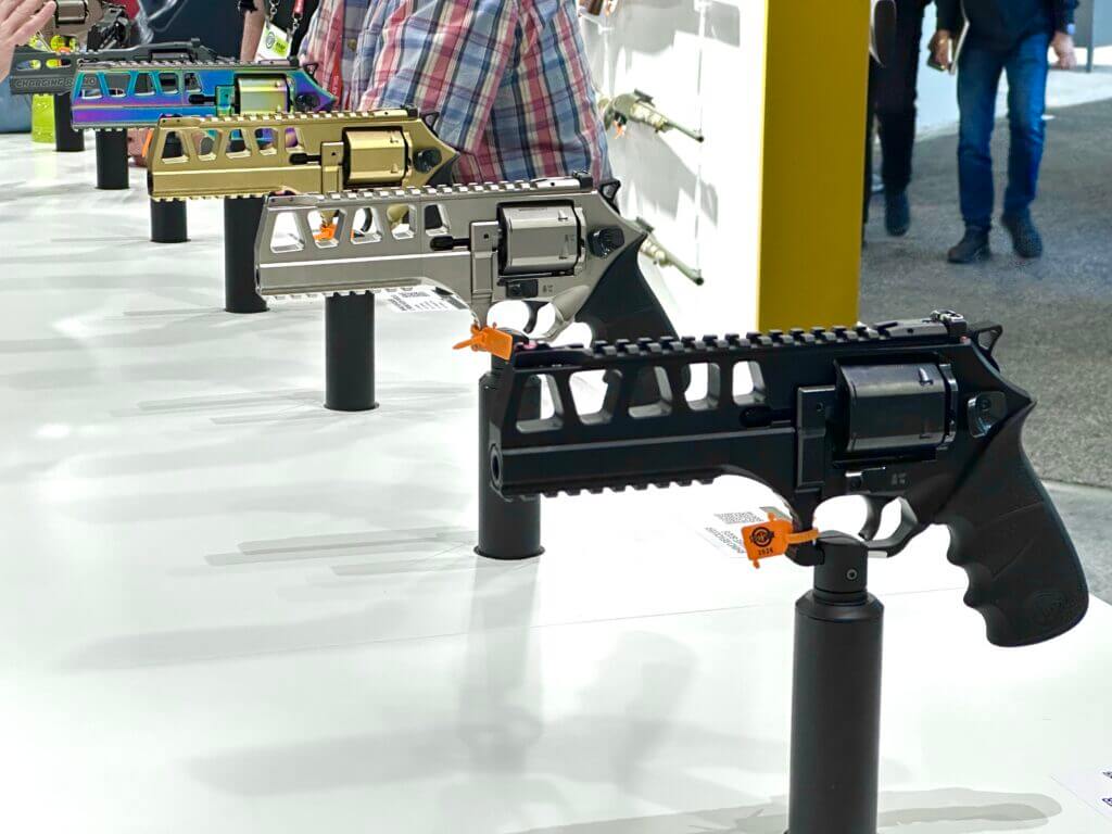 Four different colorways of the Rhino 44 mag are displayed in a row on the SHOT Show display counter.