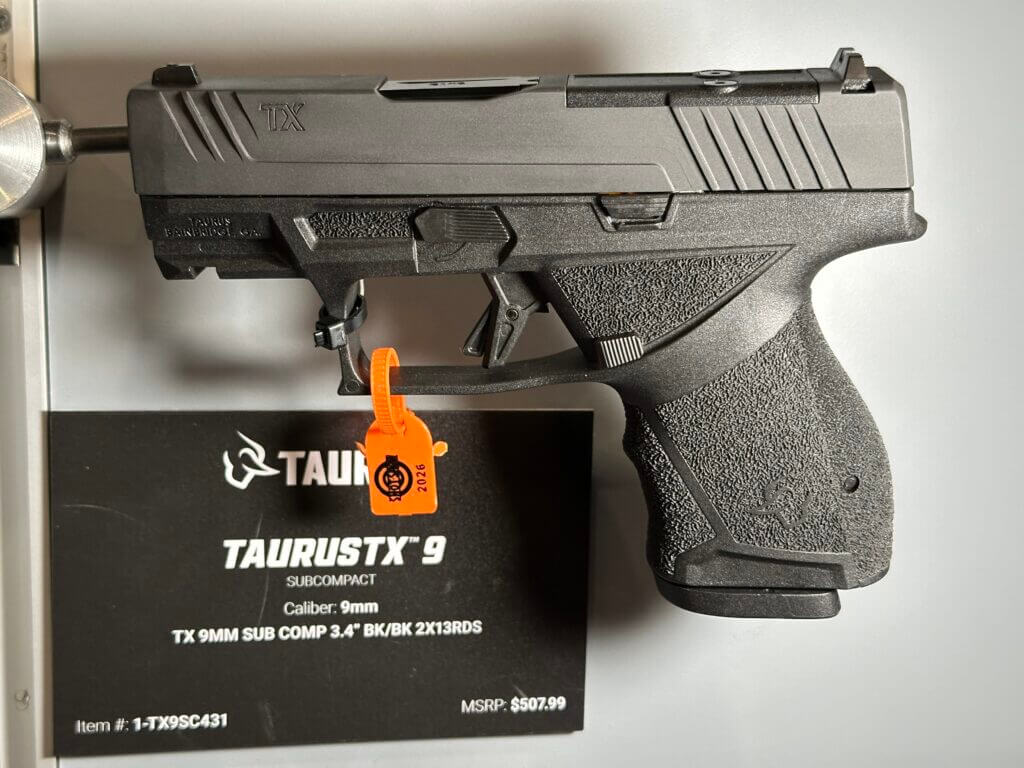 A black pistol is shown on display.