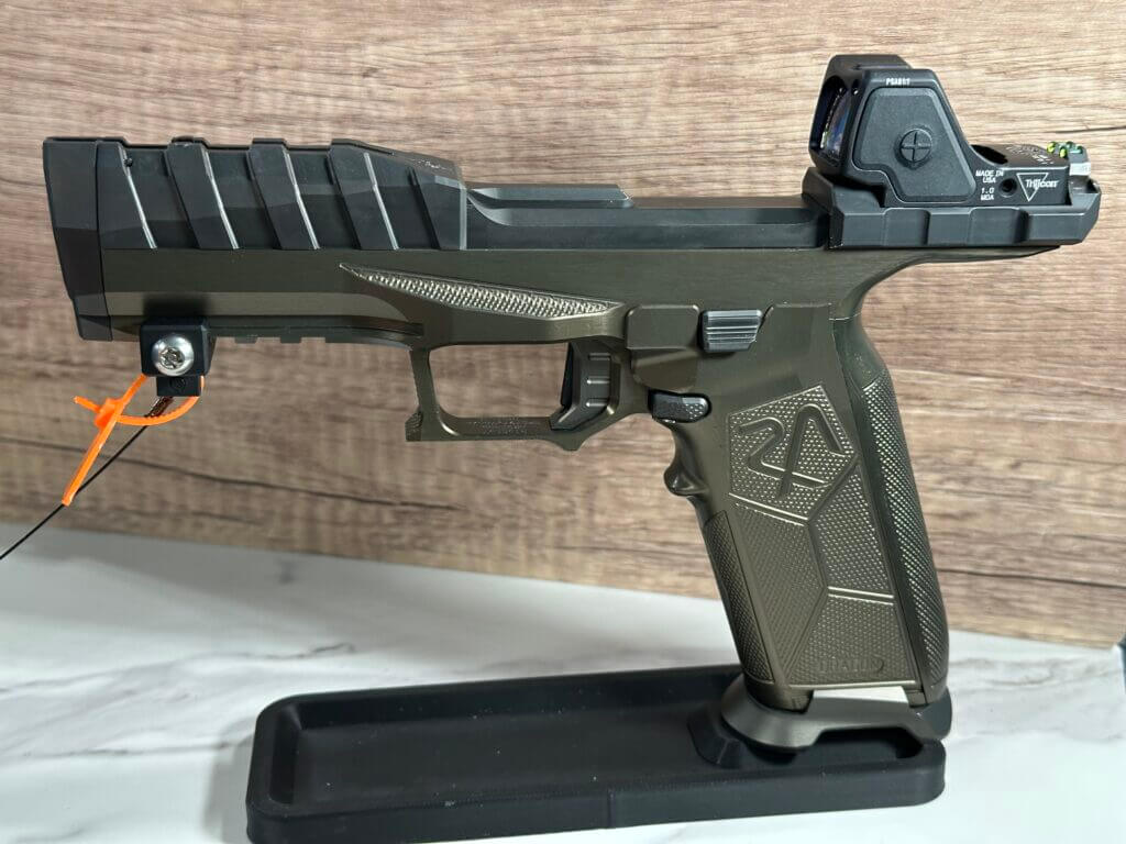 The Rideout Arsenal Dragon is positioned on a stand, pointing to the left. 