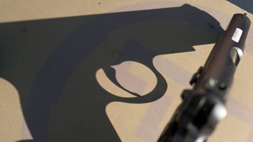 The gun's shadow cast on the table.