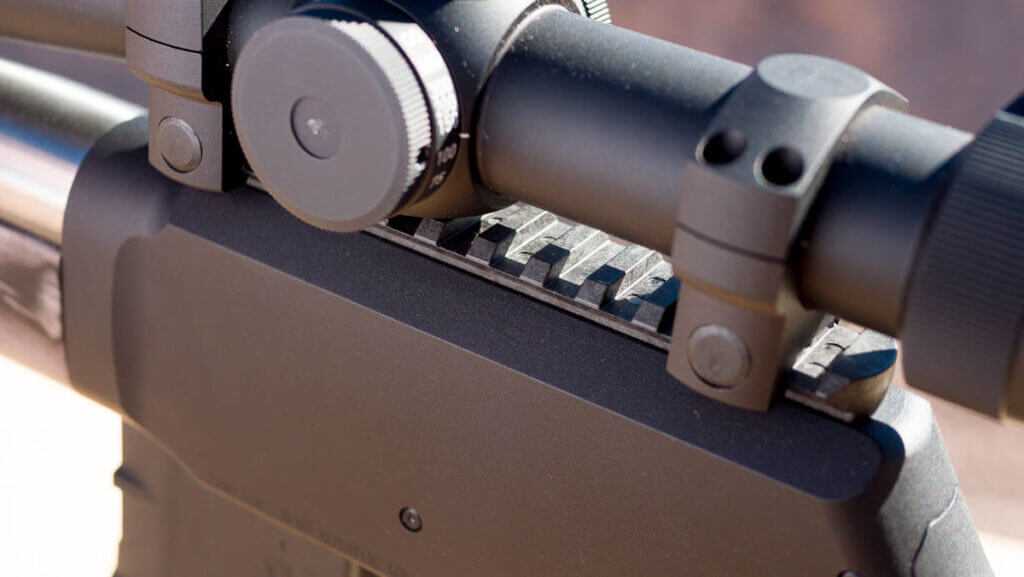 close up of the picatinny rail with an optic mounted.