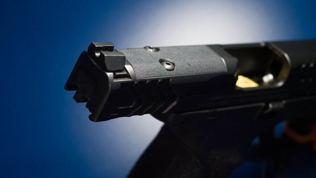 The rear right side of the slide with the slide retracted showing the optics plate.