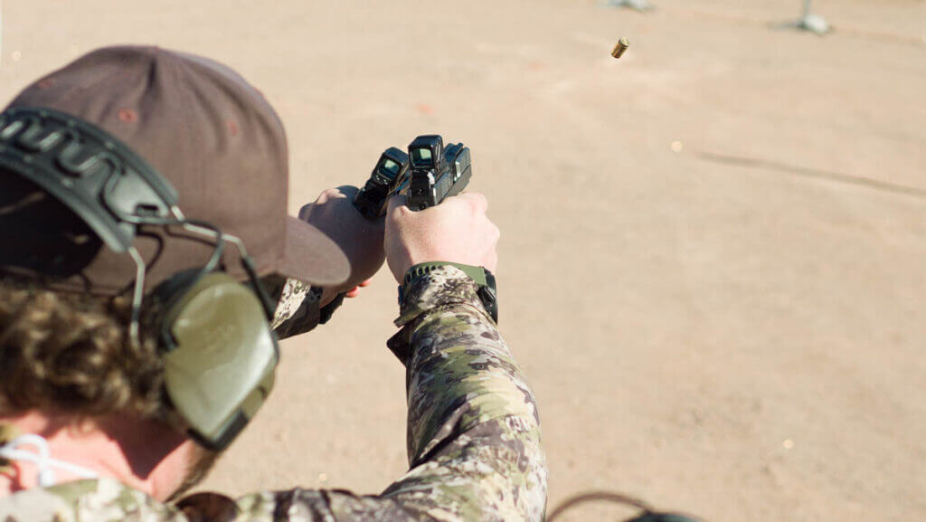 shooter at the range shooting with both left and right-handed guns.