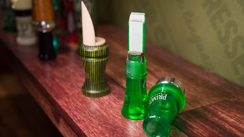 Close up view of a green call separated into two pieces showing the threaded connection.