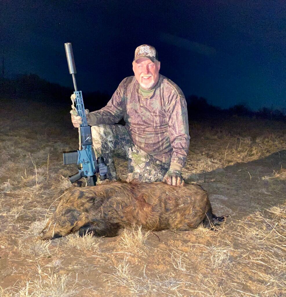 Mike B. holding his first thermal hog after using Armasight Commander 640 during Texas night hunt
