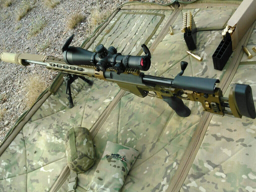 Long range rifle shooting with suppressor illustrating hearing protection and communication benefits