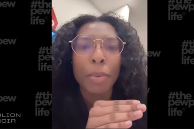 A woman pictured, discussing how difficult it is to buy a gun in a gun store.