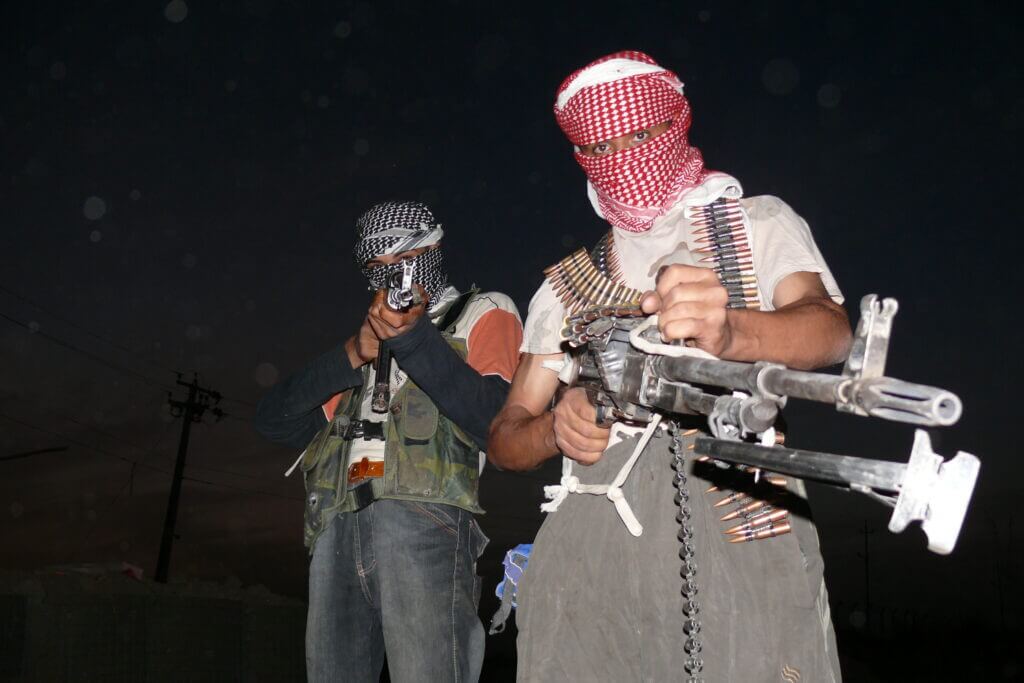 Iraqi insurgents with rifles representing militia threats tied to Al Jameat Police Station and Operation Sinbad