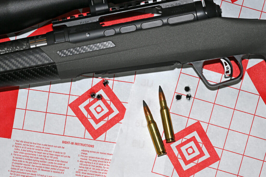 Savage 110 KLYM V2 308 Winchester accuracy testing setup with ammunition and targets