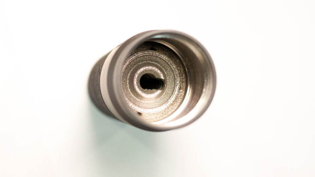 The entry end of the supproessor standing on a table.