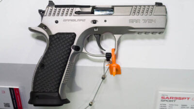 The whole gun on a table, facing right.