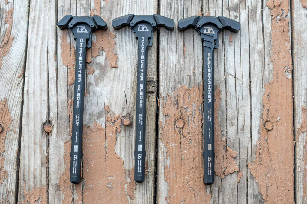 Two new Breek Arms Omni-Buster charging handles beside the original Sledgehammer for AR-15 suppressor gas comparison