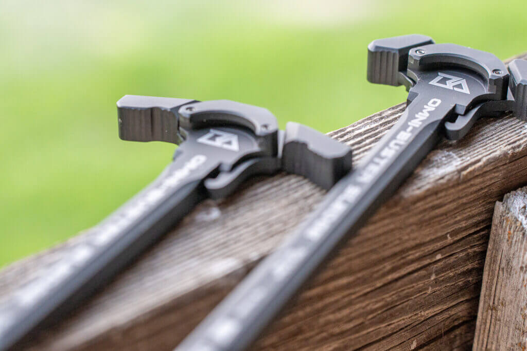 Breek Arms Omni-Buster charging handles on display showing ambidextrous AR-15 gas-mitigating design for suppressed rifle setups