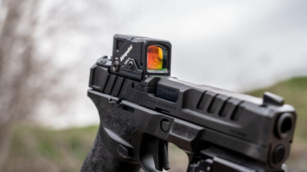 Close view of the Aimpoint COA enclosed emitter optic mounted low on the Springfield Echelon slide with A-CUT interface
