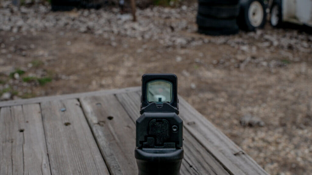 Rear sight picture through the Aimpoint COA on the Springfield Echelon showing low-profile backup irons in the bottom of the window