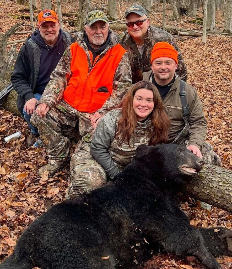 Janelle Miller with her father and grandfather after harvesting a large black bear in Cattaraugus County, NY.
