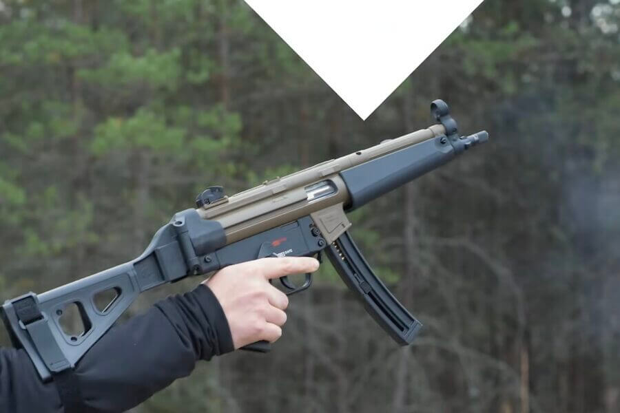 An arm holding a braced pistol.