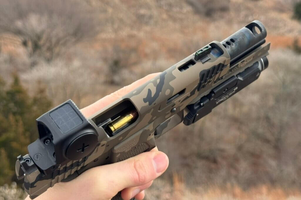 Relocated front iron sight between the front comp and barrel ports on a Stealth Arms Platypus