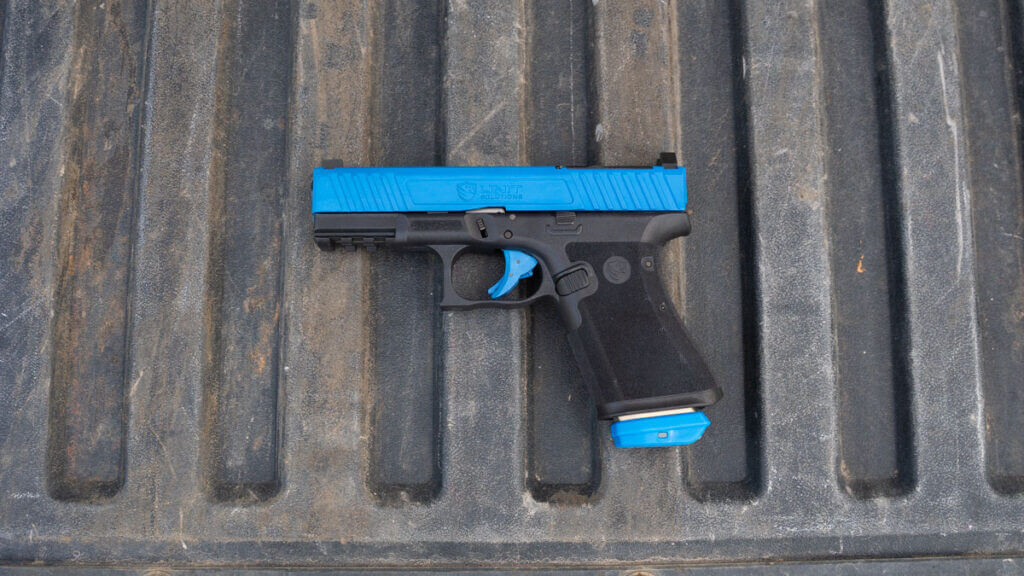 Unit 9 Compact blue slide Glock 19-style training pistol with realistic weight and controls
