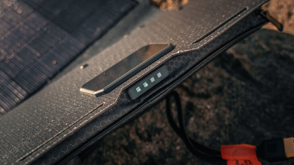 Dark Energy Spectre 56W solar panel LED sun meter showing charging efficiency in the field