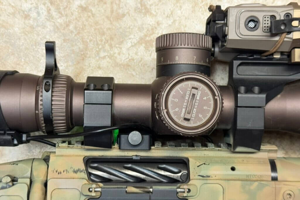 Shooters Global Pulse Pro mounted under a scope showing roughly 0.25 inches of clearance needed