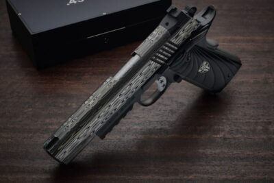Cabot Damascus Bedside 1911 pistol with patterned Damascus slide and black DLC-coated frame displayed in dramatic lighting.