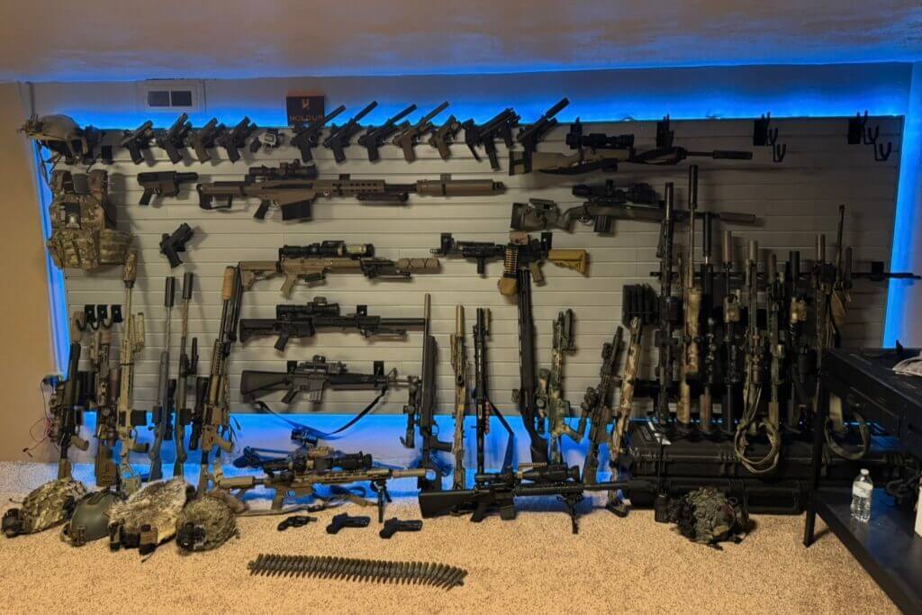 LED-backlit Hold Up Displays Gun Wall illuminating rifles pistols and tactical gear in a safe room
