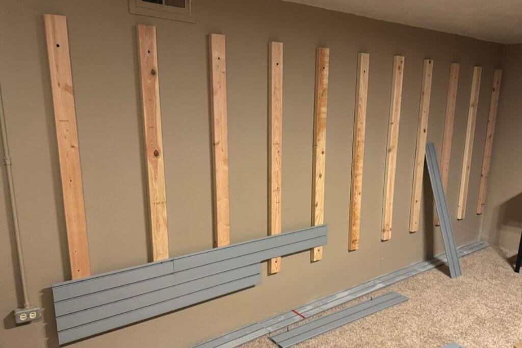 Hold Up Displays metal slats being screwed onto installed 2x4 studs in a safe room