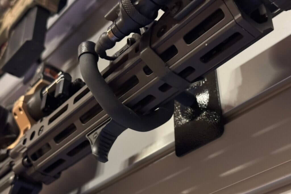 Wide rubber-coated Hold Up Displays hooks supporting rifles with wider handguards