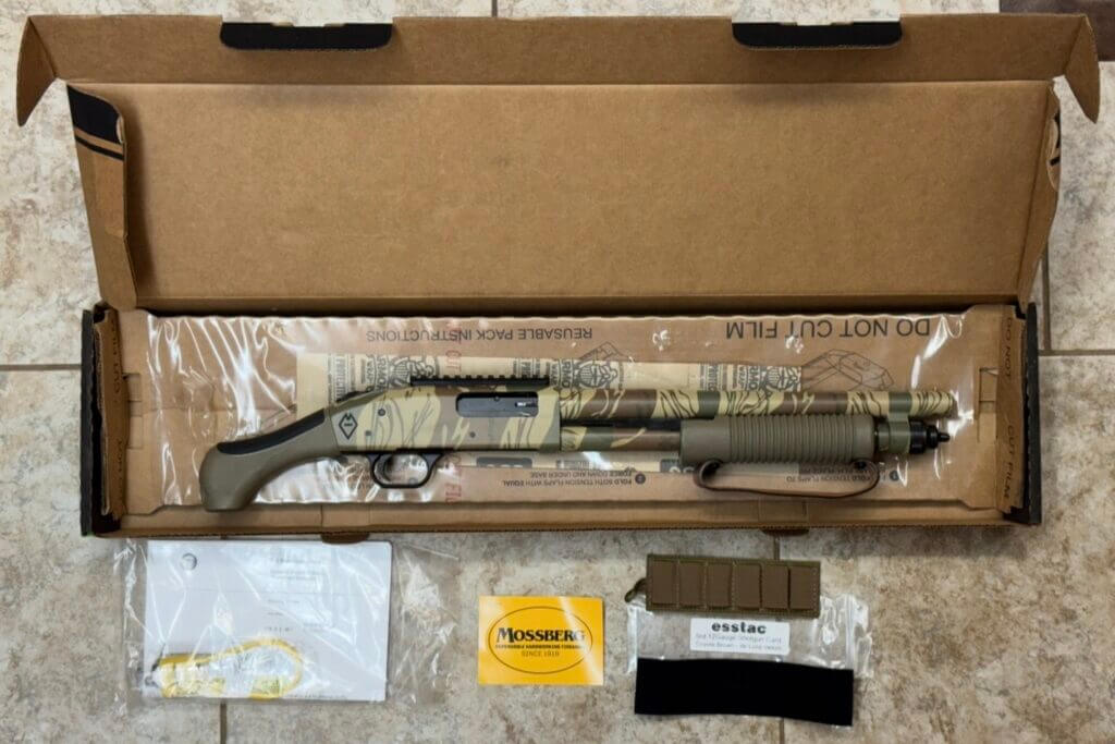 Mossberg 590 Bliksem factory contents with Esstac 6-round shell carrier, manual, lock, and sticker